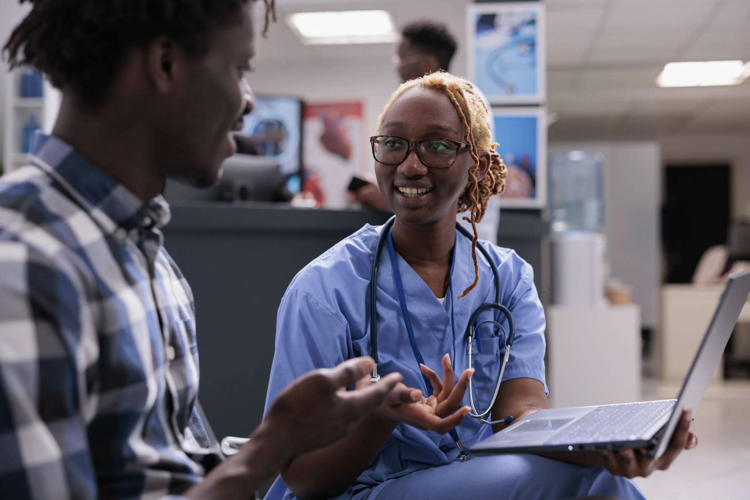 Woman nurse consulting patient at clinic